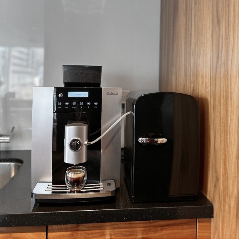 Cafesti Barista Business automatic coffee machine and milk fridge - the machine is displayed in an office kitchen with a freshly made espresso in a glass cup