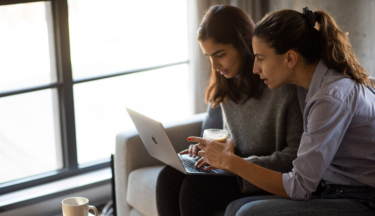 Two colleagues working over coffee in a bright office