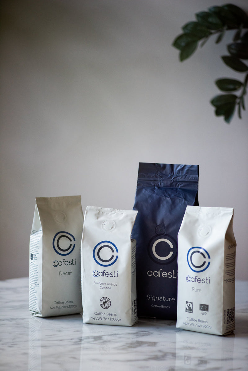 Cafesti coffee beans aesthetic product shot - multiple bean blends displayed on marble top 
